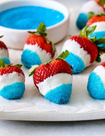 White chocolate covered strawberries dipped in blue sugar