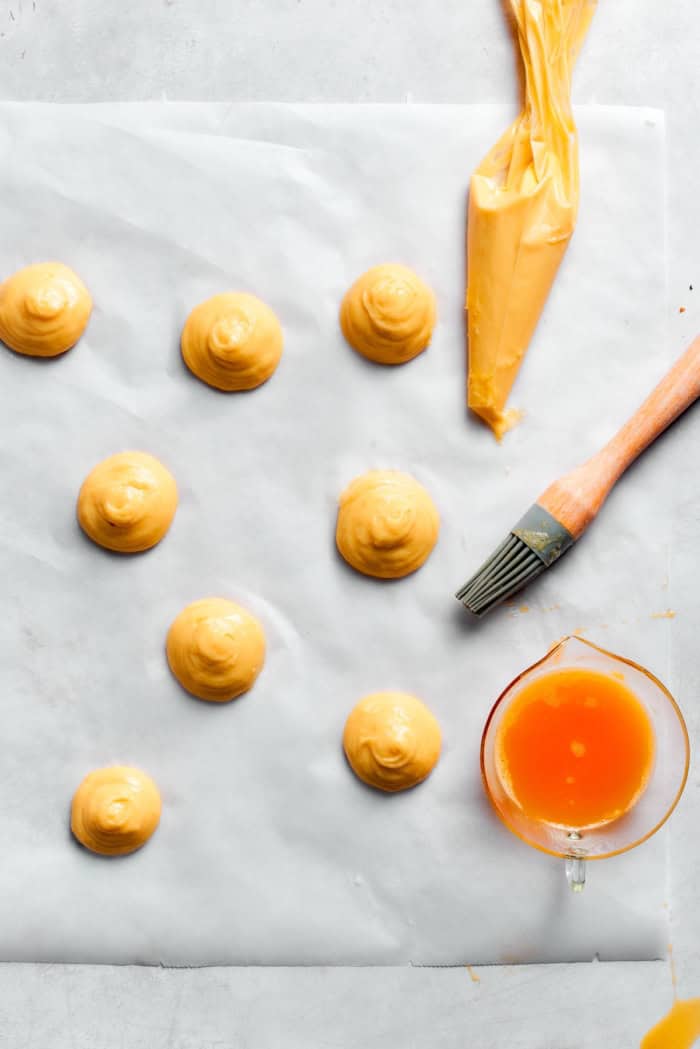 Overhead view of choux piped onto parchment