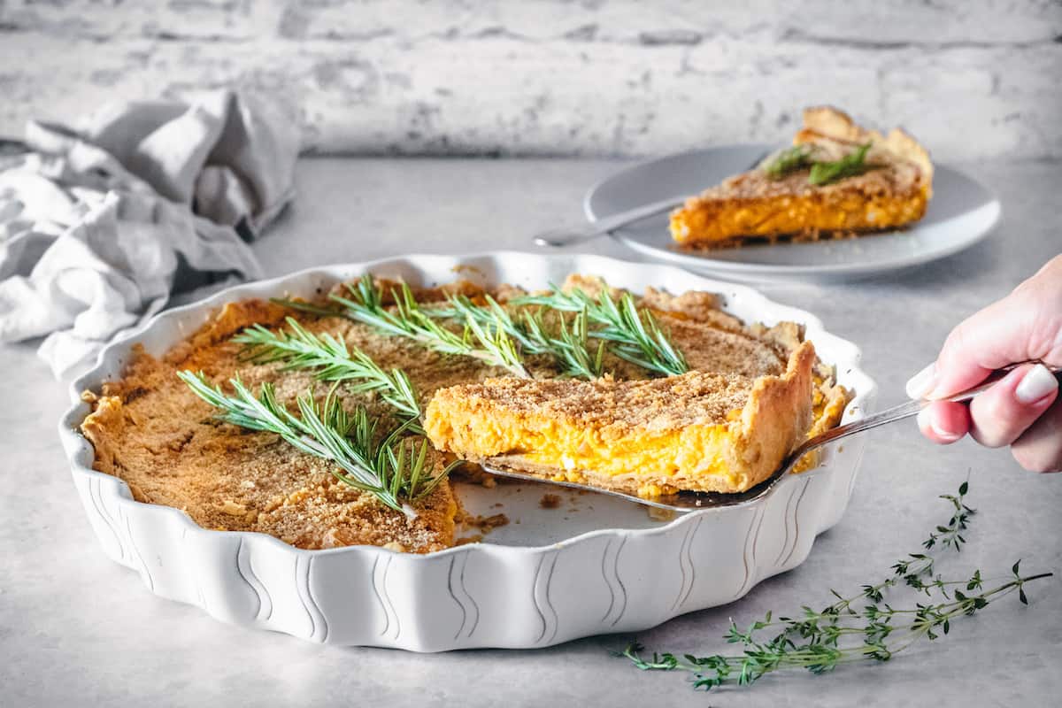 Butternut squash with caramelized onions in a white tart pan