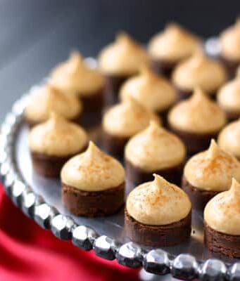 espresso brownie bites topped with kahlua buttercream on a silver cake stand