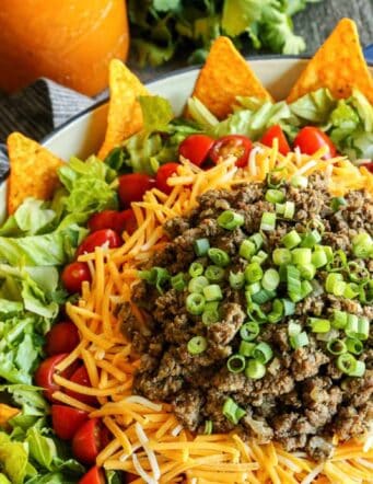salad with taco ingredients layered on top
