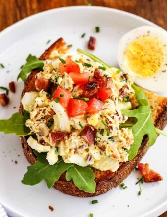 egg salad on toast, on a white plate