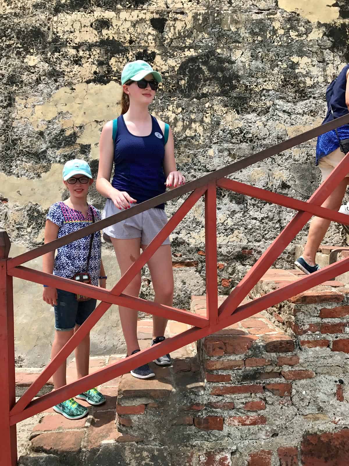 two girls on steps at Castillo de San Felipe de Barajas in Cartagena, Colombia