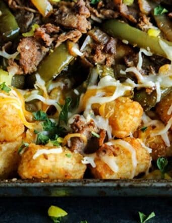 Tater tot nachos with shredded steak, peppers and cheese
