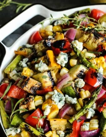 grilled vegetable salad in a large white bowl