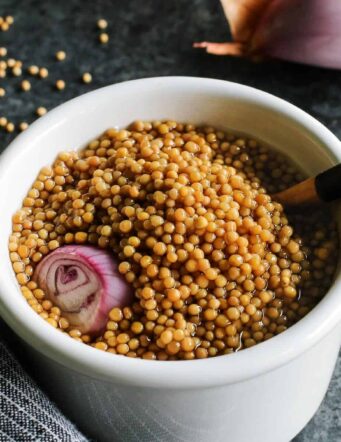 pickled mustard seeds with a wooden spoon