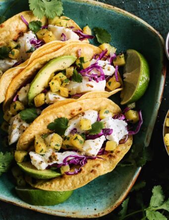 fish tacos with roasted pineapple on a plate