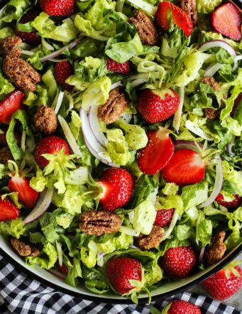 salad bowl of fresh lettuce, strawberries, and candied pecans