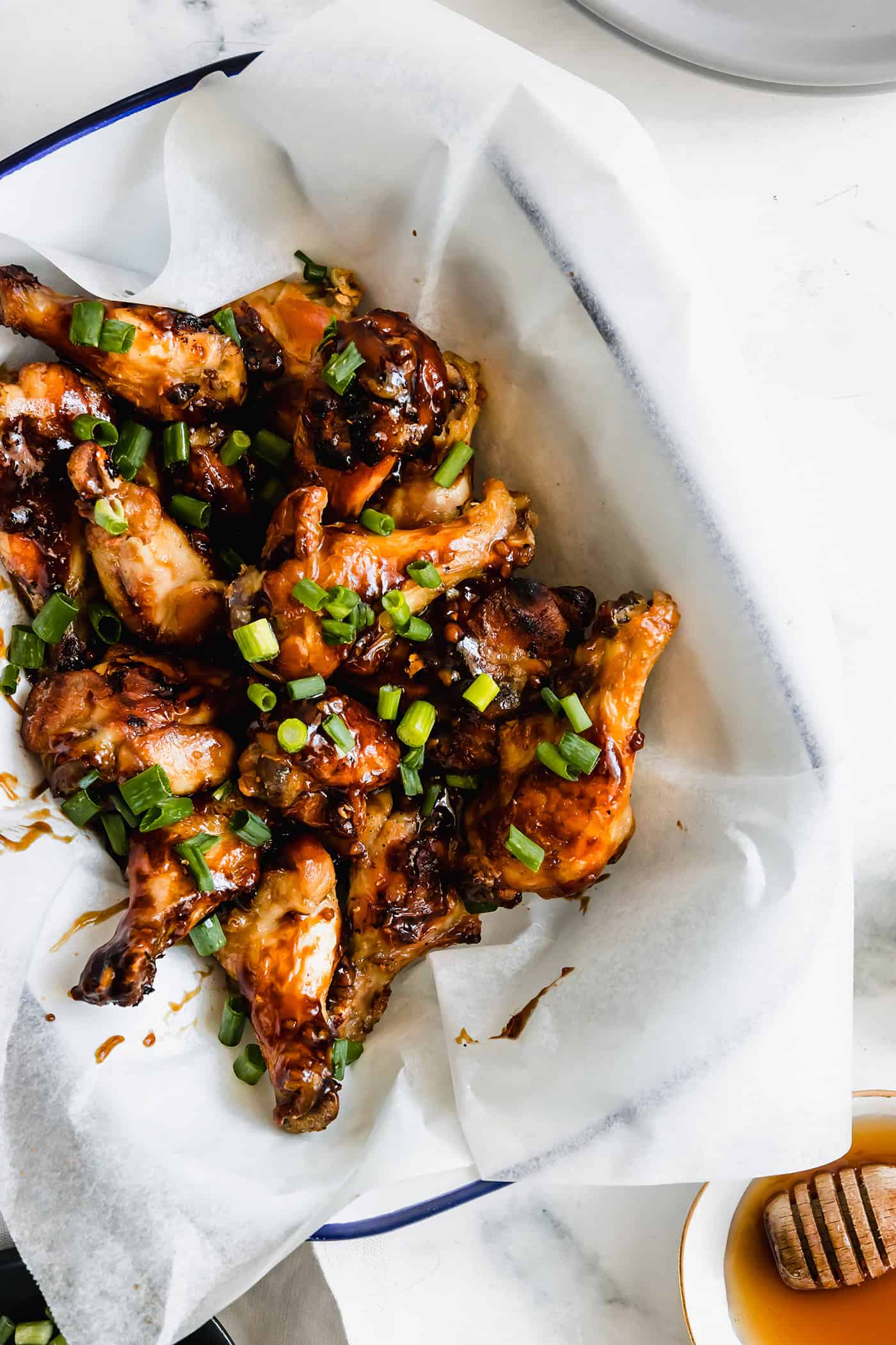 crispy oven chicken wings with oyster sauce in a white tray lined with parchment paper