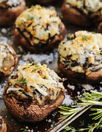baked potato and wild rice stuffed mushrooms on a rimmed sheet pan