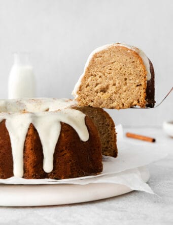 a spatula lifting a slice of cake out of the apple bundt cake