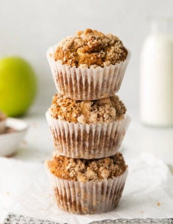 3 muffins with apples and crumble topping, stacked on top of each other