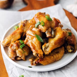 Angled view of a plate of hot honey chicken wings