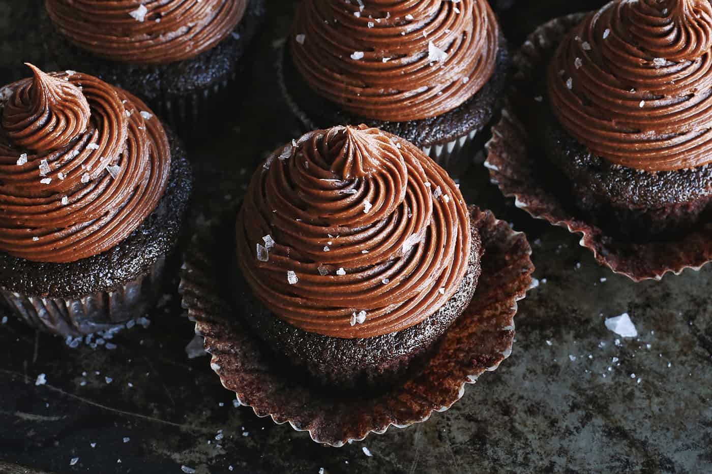 Overhead view of a chocolate cupcake topped with chocolate buttercream