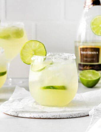a margarita with a salted rim, plus a bottle of prosecco