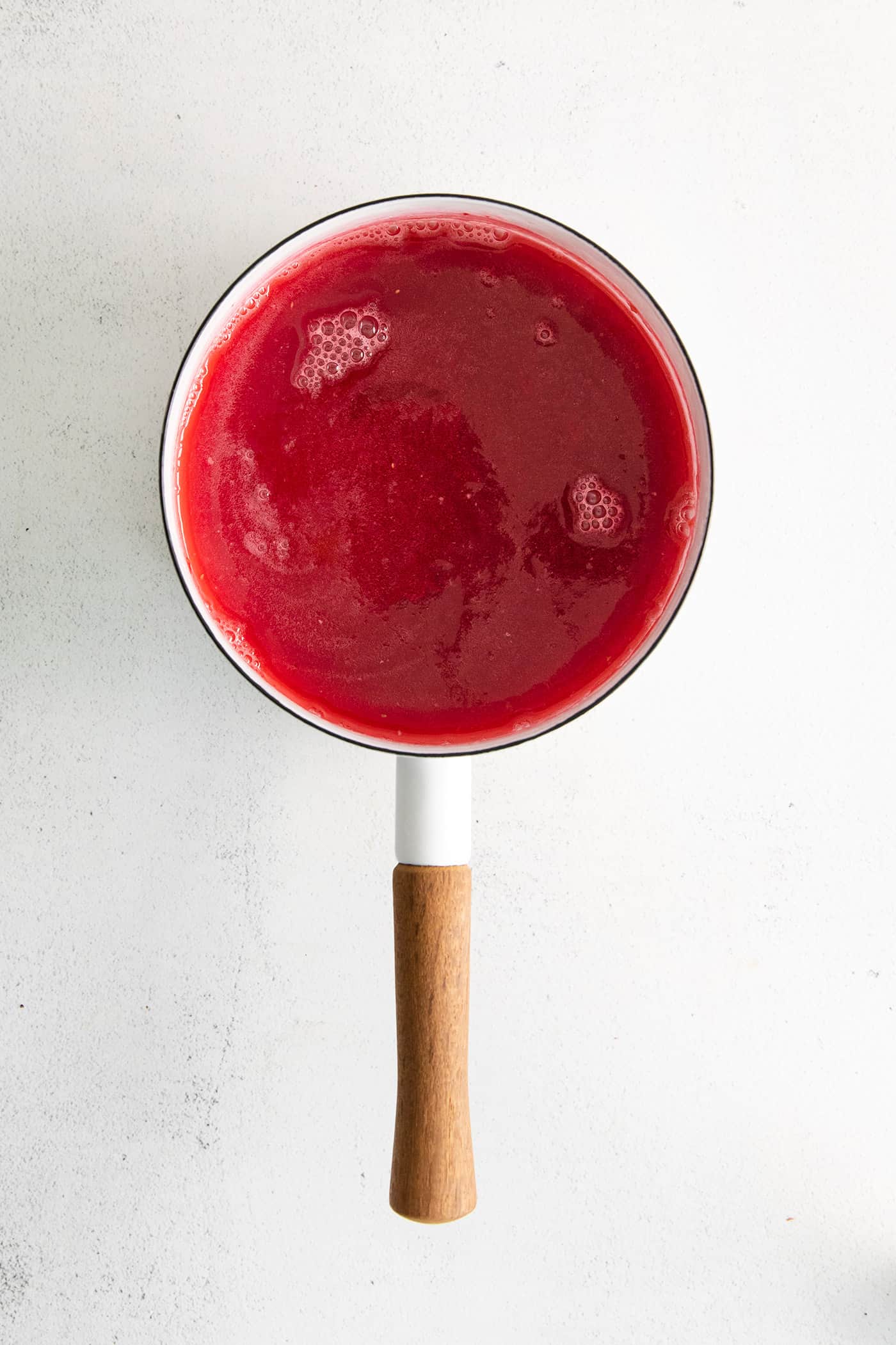 Raspberry rhubarb syrup in a saucepan