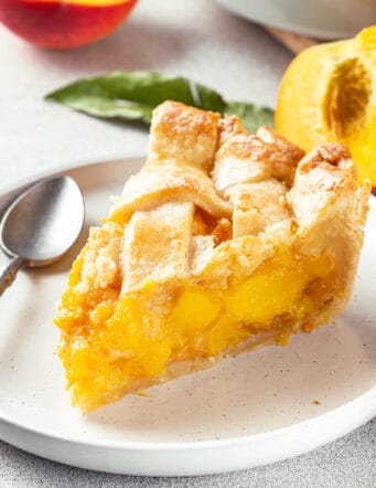 a piece of peach pie on a plate