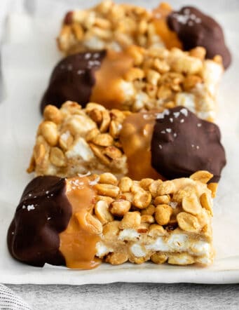 chocolate dipped salted nut rolls on a white plate