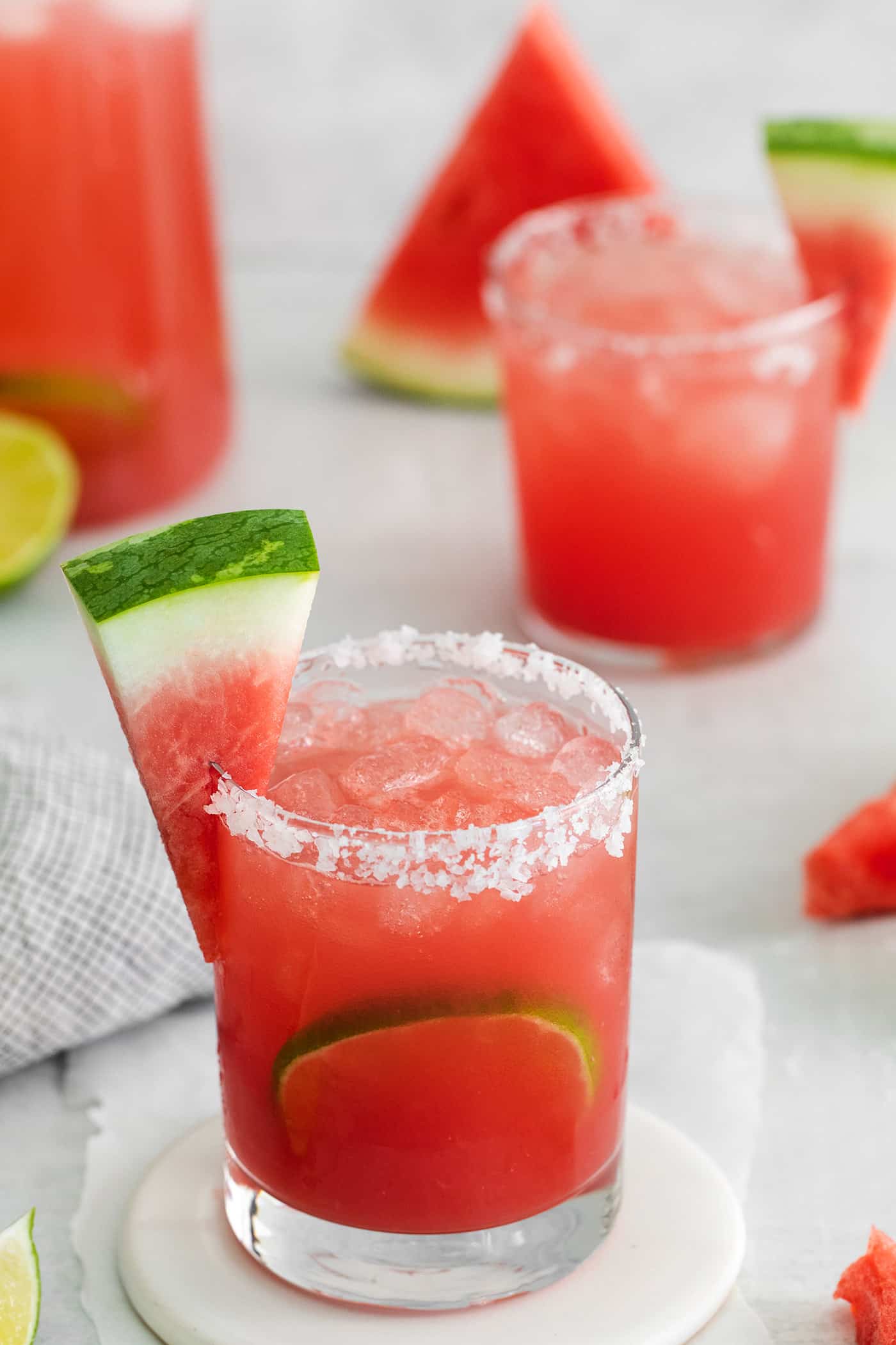close-up photo of salt-rimmed glass of watermelon margarita