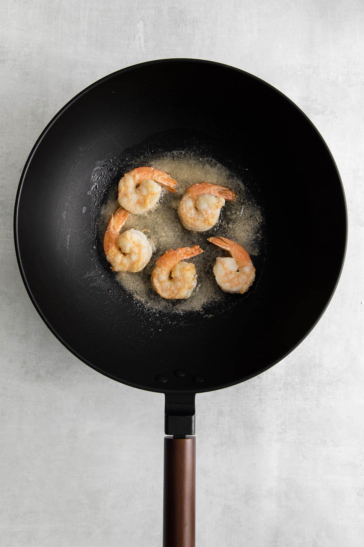 Shrimp frying in a cast iron skillet