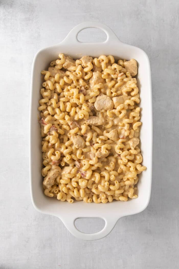 The ingredients for chicken ranch pasta are placed in a large baking dish.