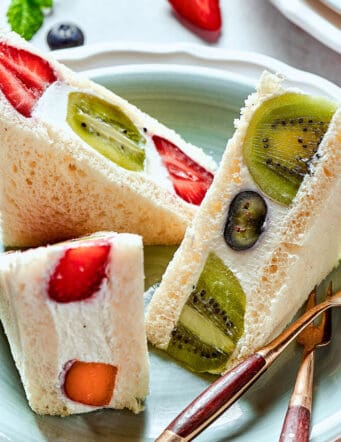 sandwich triangles made with soft bread, fluffy whipped cream, and fresh fruit