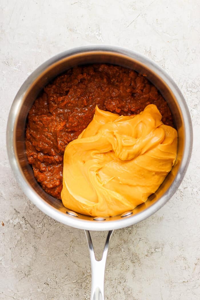 Cheez whiz and chili are combined in a pot.