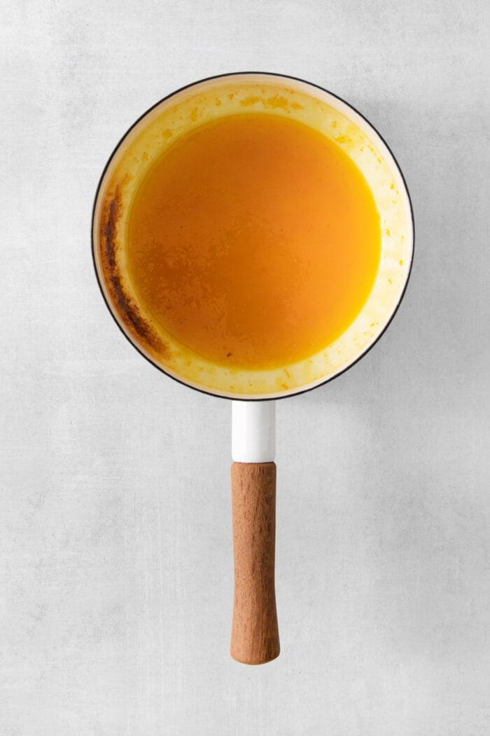 A pot of orange sauce for crepes Suzette.