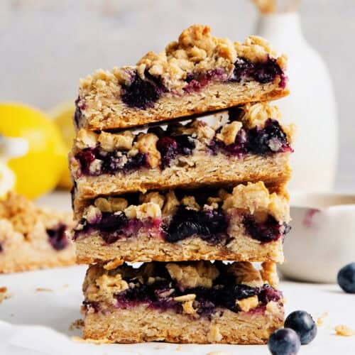 A stack of four blueberry crumble bars.