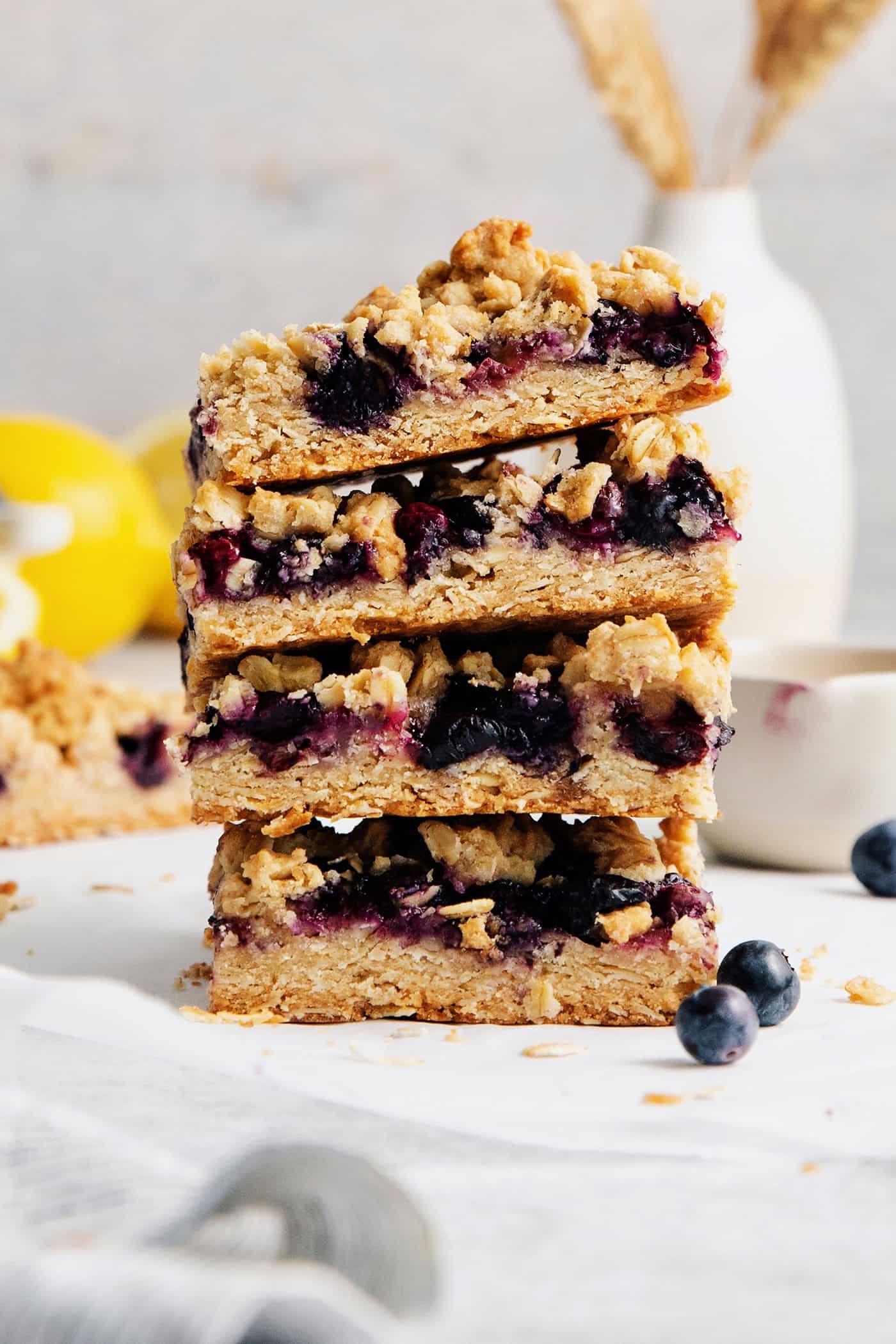 A stack of four blueberry crumble bars.