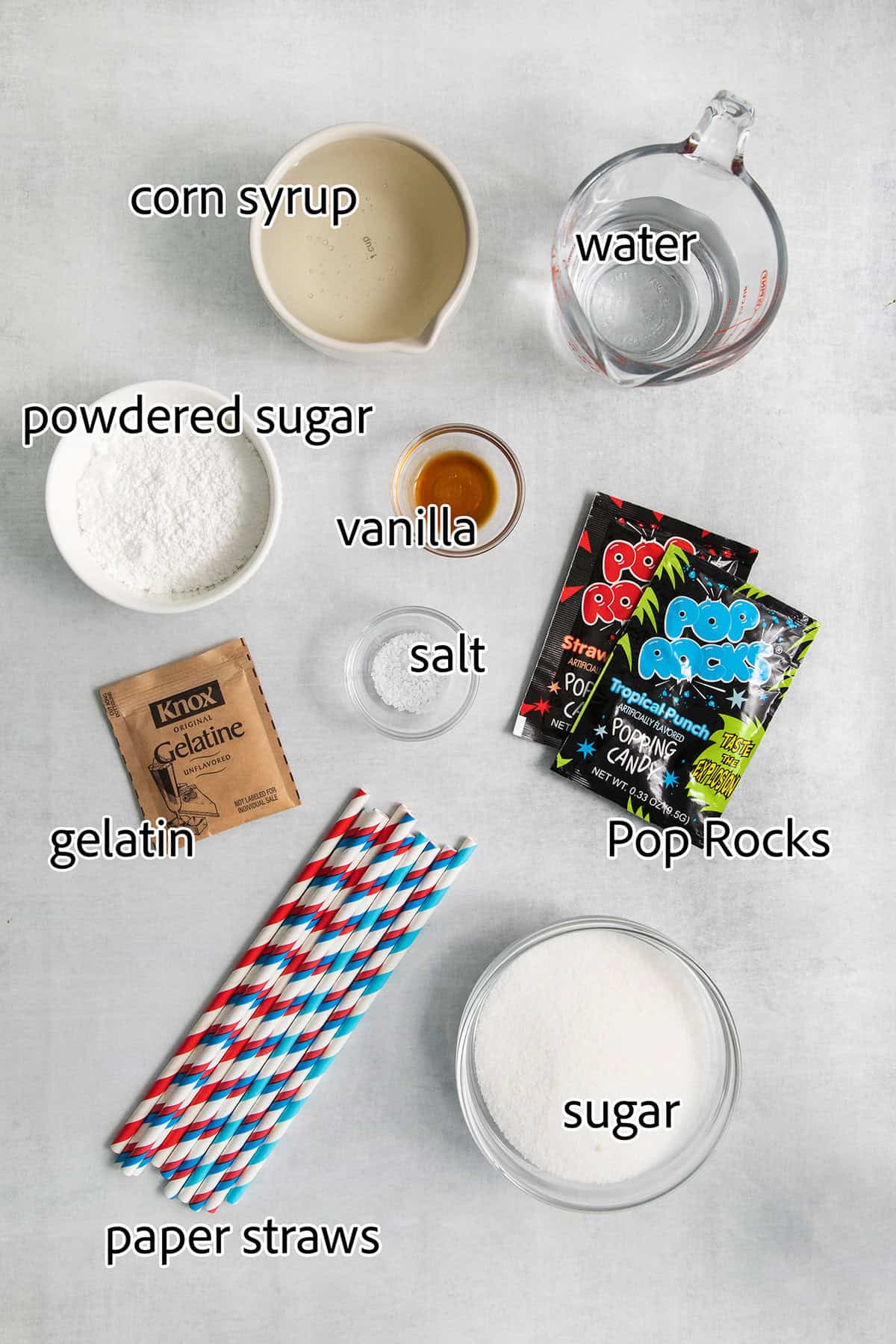 Ingredients for Patriotic Marshmallow Pops: gelatin, powdered sugar, Pop Rocks, straws, sugar, corn syrup, water, salt, vanilla.