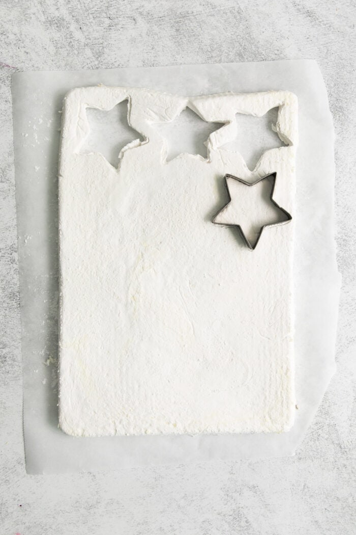 Star cookie cutters cut out marshmallows.