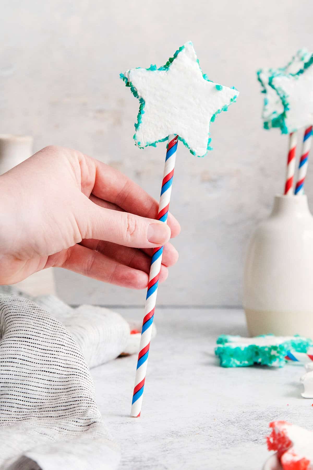 A hand holds a Patriotic Marshmallow Pop.