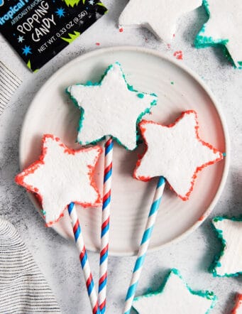overhead photo of star-shaped marshmallows with Pop Rocks, on sticks