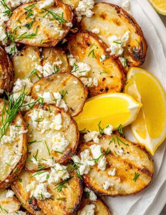 grilled potato slices topped with dill, feta, and fresh lemon