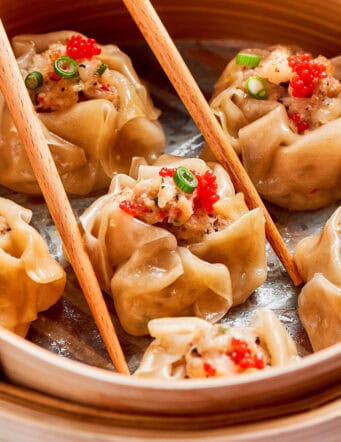 shrimp shumai dumplings in a bamboo steamer basket